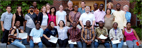 Teachers and faculty pose for group photo in front of Swing Dorm